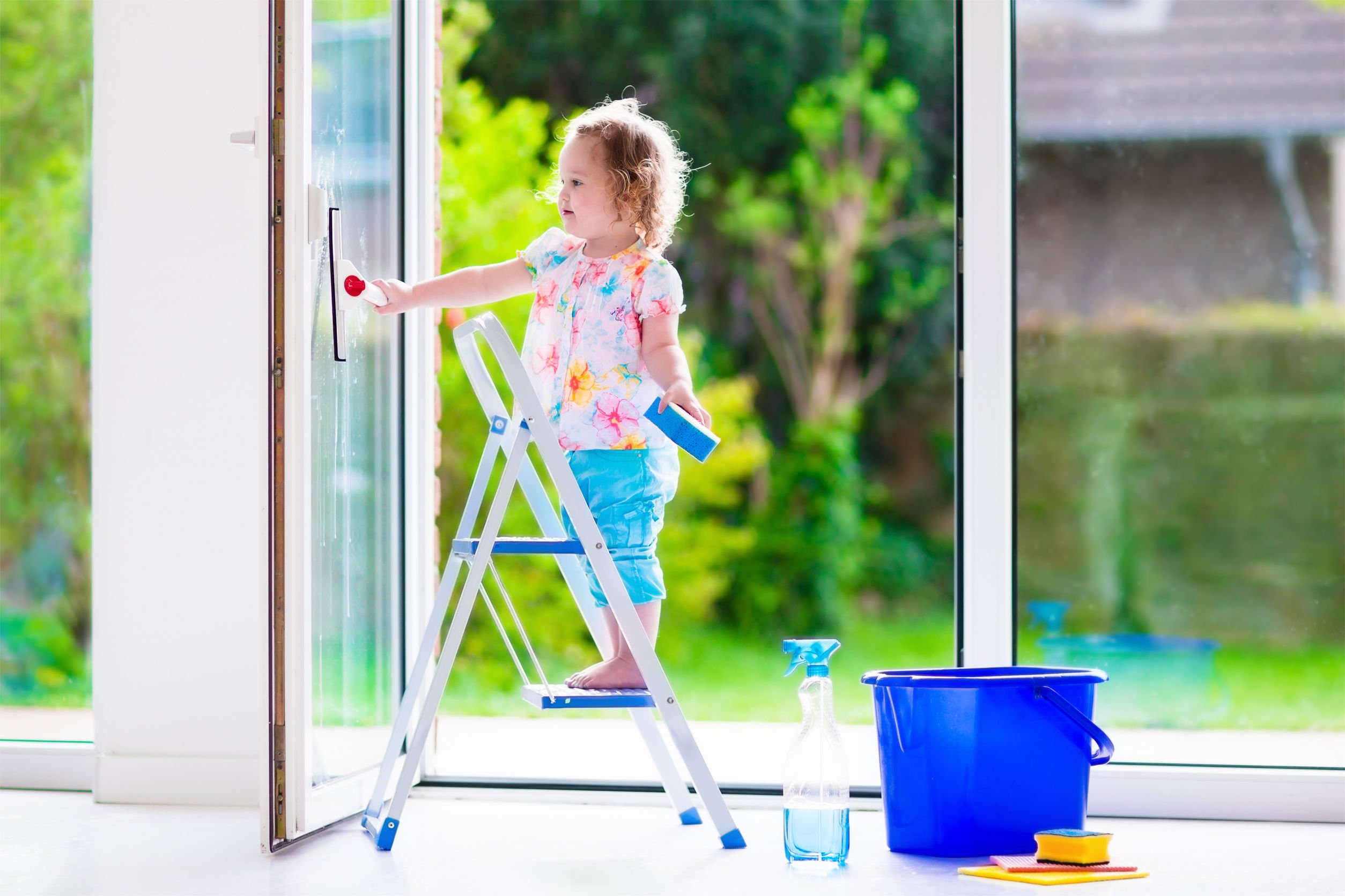 Petite fille lavant les vitres d'une fenêtre, prix des fenêtres, nouvelle fenêtre, prix de nettoyage de fenêtre
